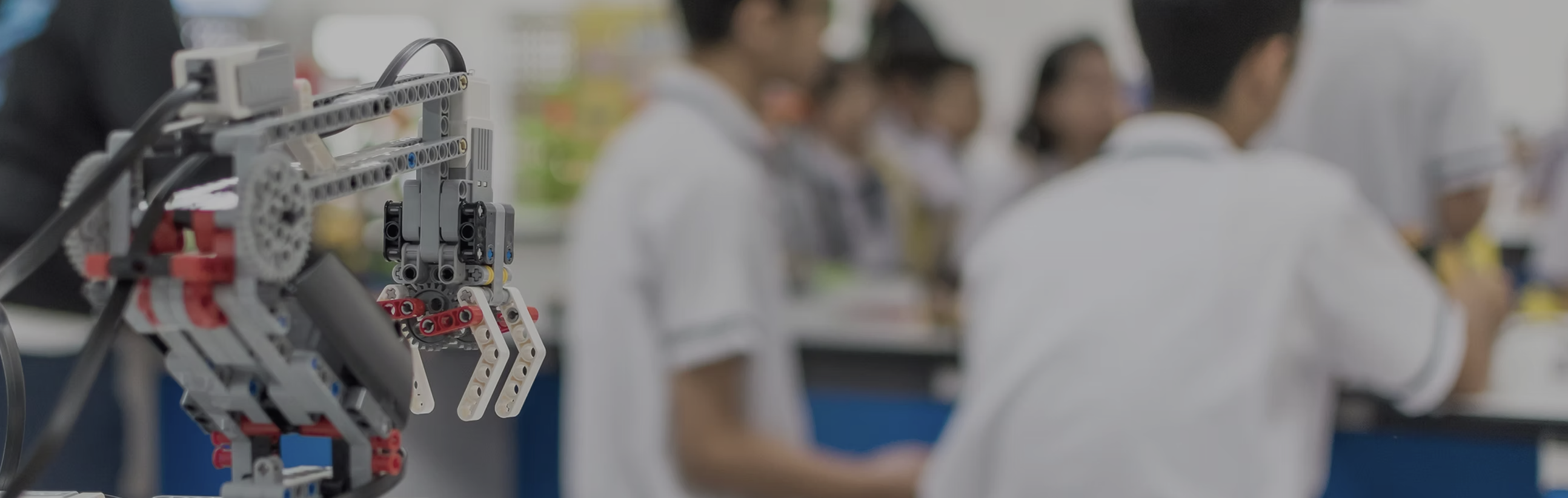 Startup Innovation - Robotic arm and students in workshop